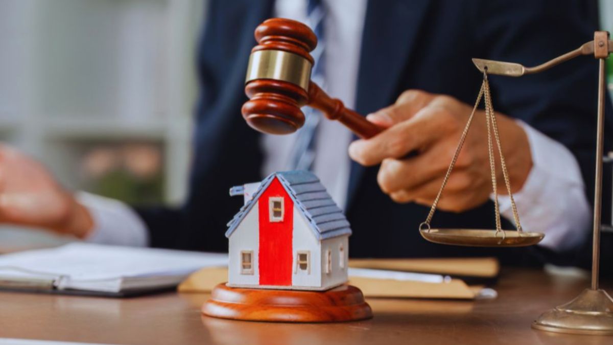 A judge's gavel is placed on a house model, with a scale model of a house in the background, emphasizing property rights in Hilton Head, SC.