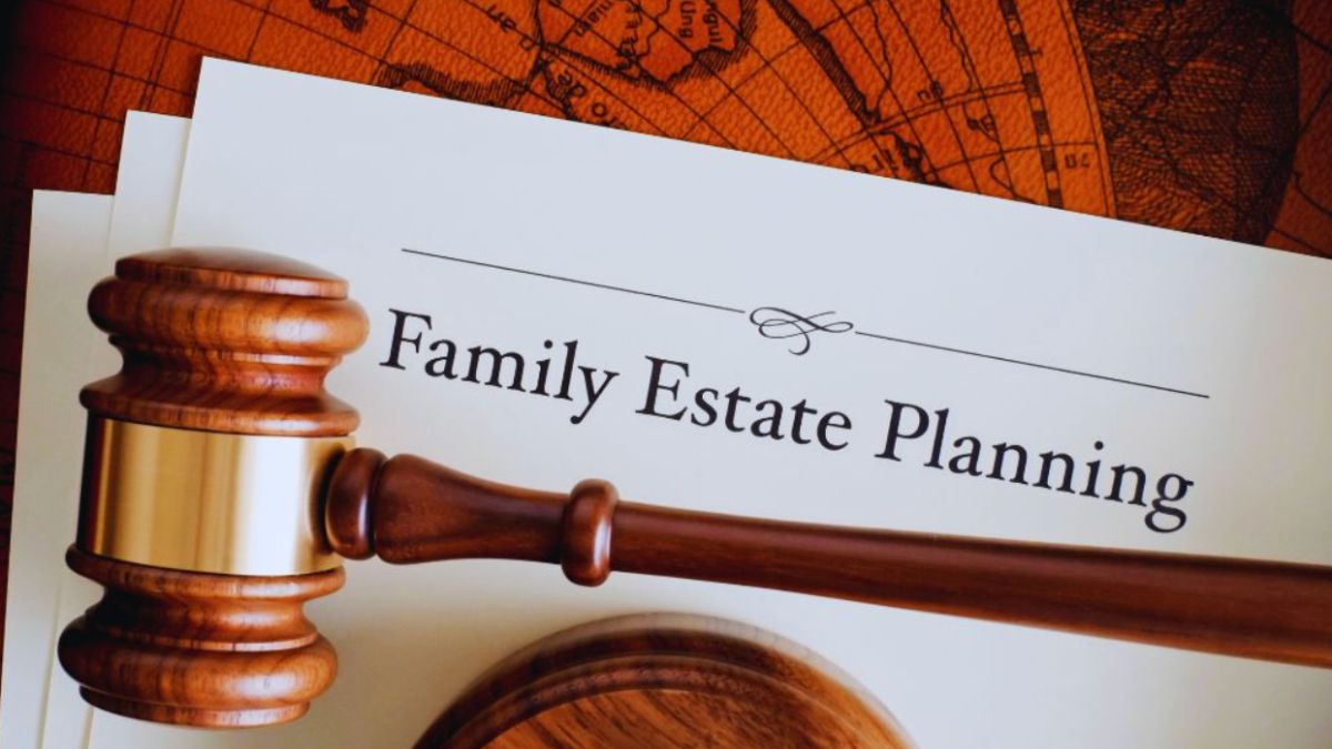 A wooden judge’s gavel rests beside documents labeled "Family Estate Planning," emphasizing legal protection and planning for a family's future, including children, on a desk.