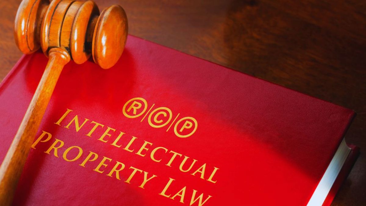 Hardcover legal textbook used as a symbolic image of real property rights, placed on a wooden table beside a judge’s gavel.
