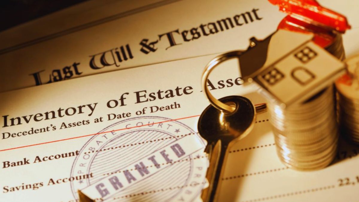 A close-up of an estate inventory document labeled “Inventory of Estate Assets,” placed beneath a “Last Will and Testament.” A metal house keychain sits on stacked coins beside a “Probate Court Granted” stamp, representing the probate assets list and the process of identifying a decedent’s financial and property assets.