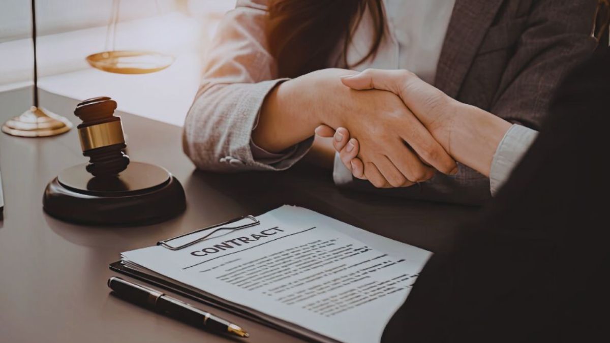 Contract Law Bluffton agreement showing two parties shaking hands over a signed contract on a desk with a gavel, symbolizing a legally binding contract.