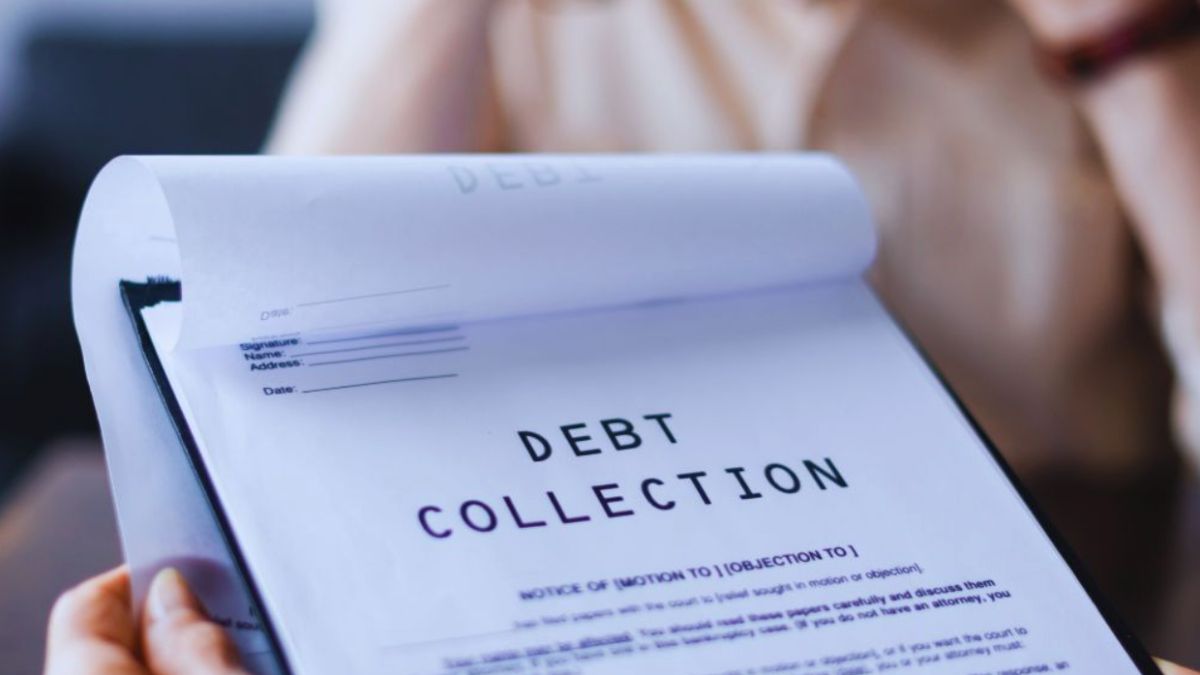 Close-up of a person holding a legal document labeled ‘DEBT COLLECTION’ on a clipboard, representing professional Debt Collection Services in Bluffton.