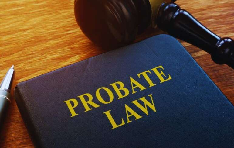 Leather-bound book titled “Probate Law” next to a judge’s gavel and pen on a wooden desk, illustrating probate lawyer and estate administration concepts.
