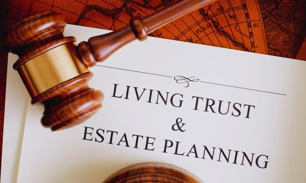 Wooden judge’s gavel resting on a document titled ‘Living Trust & Estate Planning’ against a background of an old world map, symbolizing legal guidance for estate planning.
