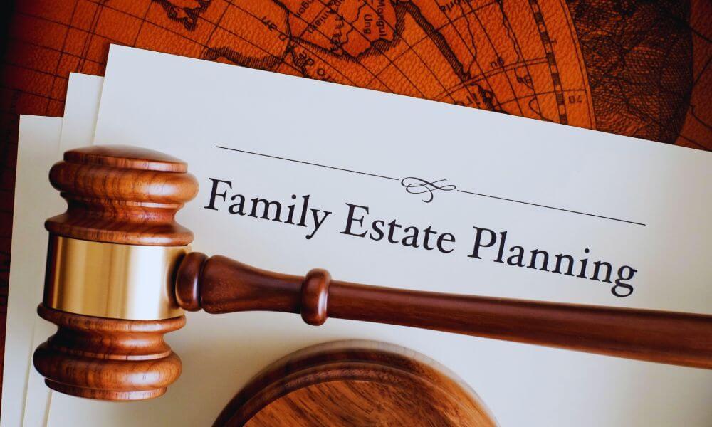 Wooden judge’s gavel resting on a legal document titled ‘Family Estate Planning’ against a vintage world map background, representing legal guidance for family estate planning.
