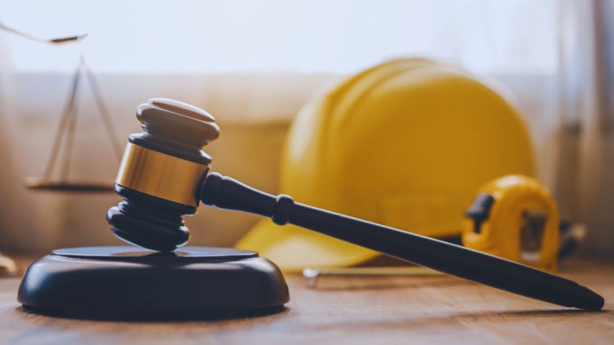 Judge's gavel with a construction hard hat and measuring tape in the background, representing legal services from a Bluffton construction accident lawyer for injured workers.