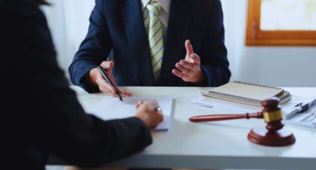 South Carolina living will attorney meeting with a client to review advance-care planning documents at an office desk.