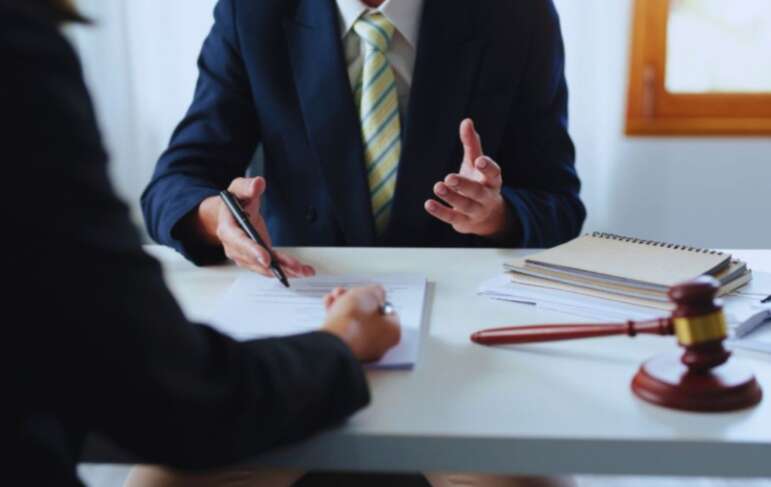 South Carolina living will attorney meeting with a client to review advance-care planning documents at an office desk.