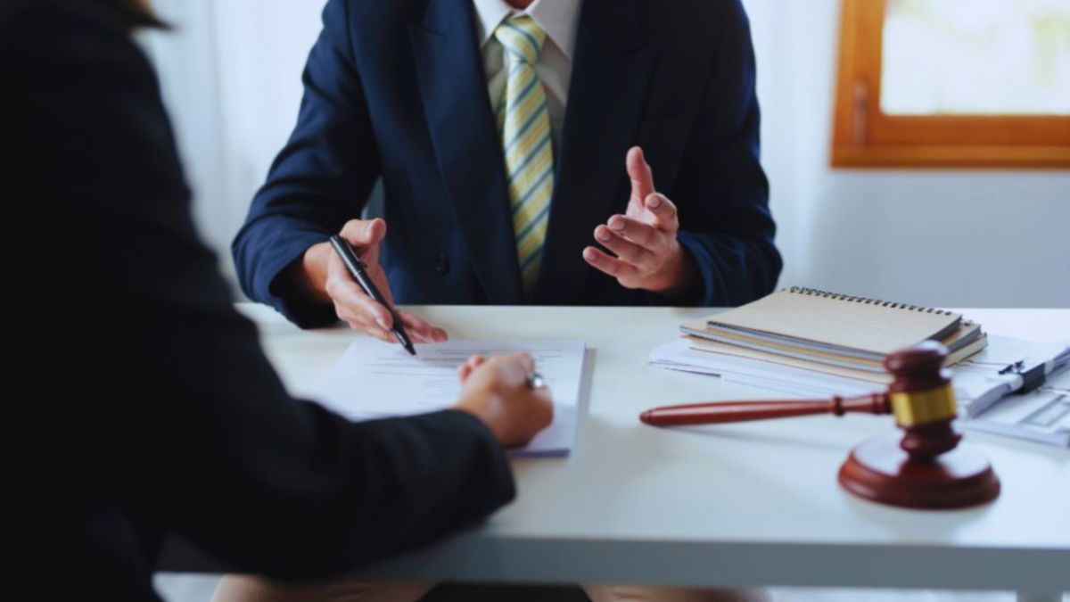 South Carolina living will attorney meeting with a client to review advance-care planning documents at an office desk.