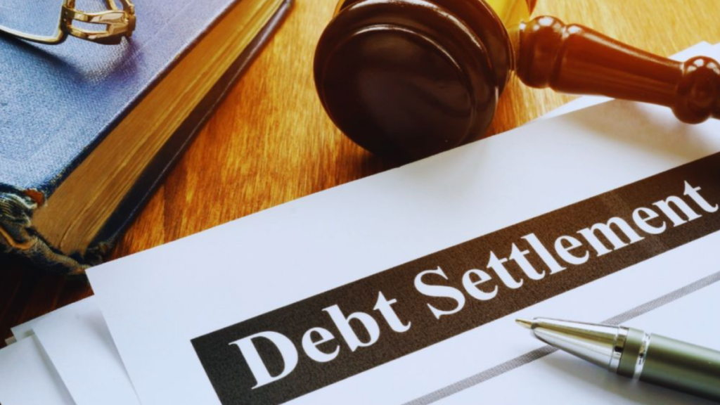 Debt settlement attorney reviewing debt settlement documents with a gavel and pen.