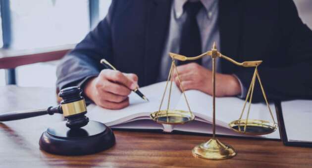 Debt collection attorney reviewing financial documents and account records in a South Carolina office.