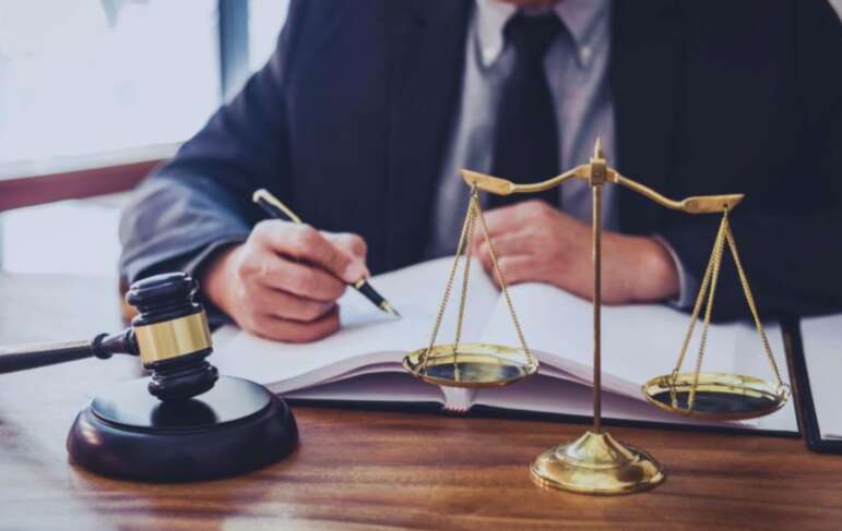 Debt collection attorney reviewing financial documents and account records in a South Carolina office.