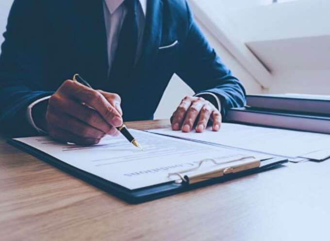 Construction litigation attorney in Hilton Head, SC, reviewing and signing legal documents at a desk.