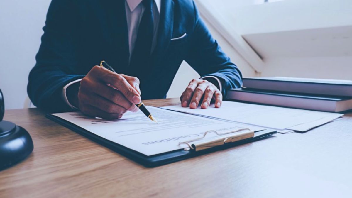 Construction litigation attorney in Hilton Head, SC, reviewing and signing legal documents at a desk.